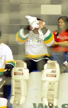 FOR THE RECORD: the girl behind him is JUST SOMEONE ON EVENT STAFF, but she probably did score a sweaty towel or two...