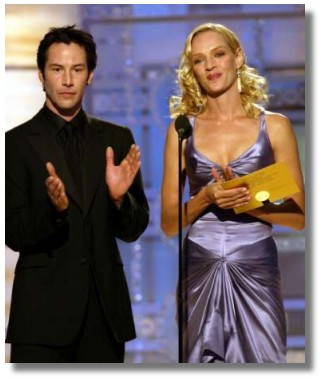 Actors Keanu Reeves (looking smashing in all black) and Uma Thurman (wow, do you have to have the perfect body to wear that dress or what?) serve as presenters during the 61st annual Golden Globe Awards in Beverly Hills January 25, 2004. REUTERS/Chris Haston/NBC/Handout