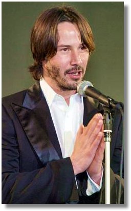 Hollywood star Keanu Reeves clasps his hands to thank for Japanese fans gathered for the premier of his latest film 'The Matrix Reloaded' in Tokyo Monday, May 26, 2003. (AP Photo/Shizuo Kambayashi)